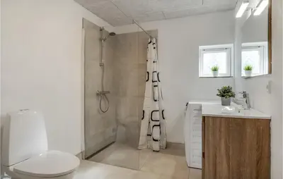 a bathroom with a shower and a toilet and a sink at Stunning Home In Nibe With Kitchen in Store Ajstrup