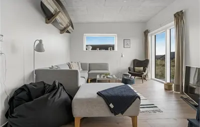 a living room with a couch and a chair at Beautiful Home In Thisted With Wifi in Thisted