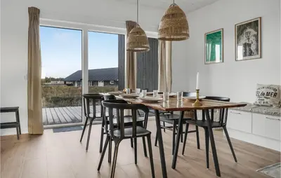 a dining room with a table and some chairs at Beautiful Home In Thisted With Wifi in Thisted
