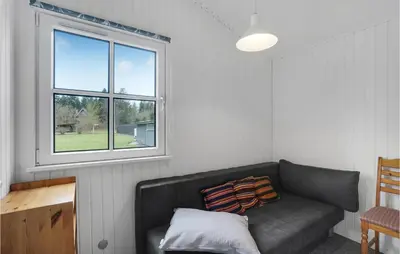 a living room with a couch and a window at 3 Bedroom Beautiful Home In Højslev in Højslev
