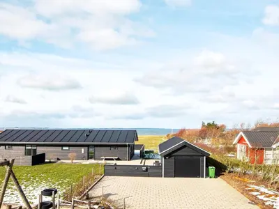 a black house with a black roof at Modern Cottage with Spa - By Traum Ferienwohnungen in Vinderup