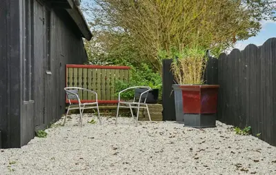 two chairs and a bench next to a fence at Awesome Home In Bedsted Thy With Wifi in Bedsted Thy