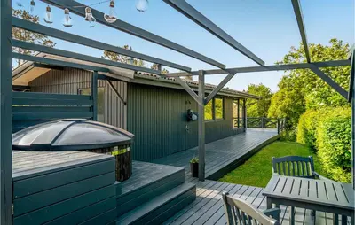 a deck with two chairs and a pergola at Lovely Home In Hurup Thy With Wifi in Sønder Ydby