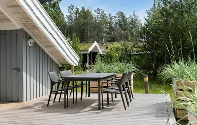 a black table and chairs on a patio at Gorgeous Home In Blokhus With Wifi in Blokhus