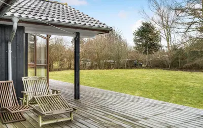 two chairs on a wooden deck with a gazebo at Amazing Home In Spøttrup With Kitchen in Spottrup