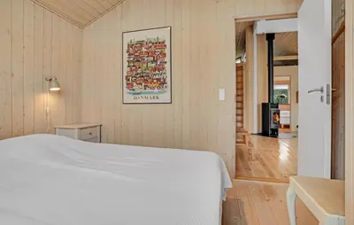 a bedroom with a bed and a painting on the wall at Amazing Home In Spøttrup With Kitchen in Spottrup