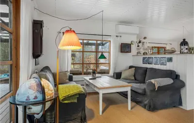 a living room with a couch and a table at 2 Bedroom Lovely Home In Højslev in Højslev