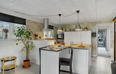 a kitchen with white cabinets and a counter top at 3 Bedroom Cozy Home In Thyholm in Thyholm