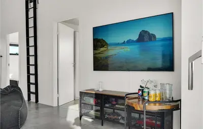 a living room with a tv on the wall at Beautiful Home In Thisted With Sauna in Thisted