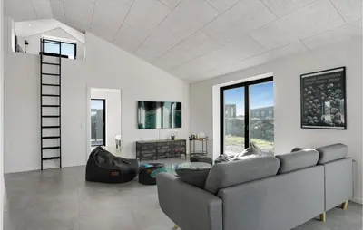 a living room with a couch and a ladder at Beautiful Home In Thisted With Sauna in Thisted