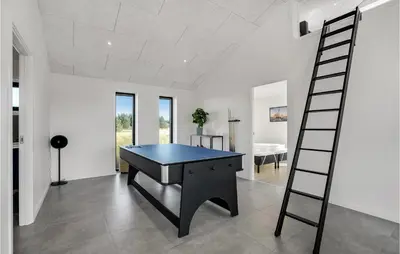 a room with a ping pong table and a ladder at Beautiful Home In Thisted With Sauna in Thisted