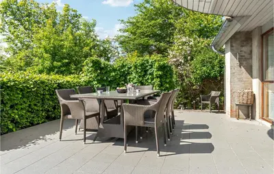 a table and chairs sitting on a patio at Gorgeous Home In Øster Assels in Øster Assels