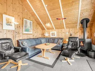 a living room with a couch and chairs and a table at Holiday Home Sofie - 150m from the sea by Interhome in Lemvig