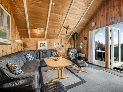 a living room with a couch and a table at Holiday Home Sofie - 150m from the sea by Interhome in Lemvig