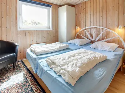 two twin beds in a room with a window at Holiday Home Suend - from the sea by Interhome in Harboør