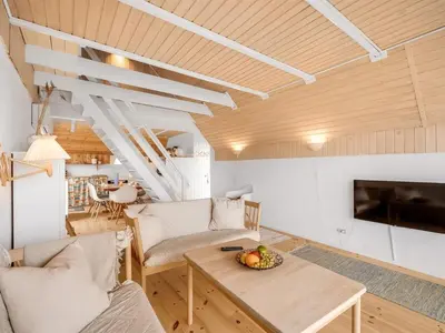 a living room with a couch and a table at Holiday Home Balthasar - 200m from the sea by Interhome in Harboør