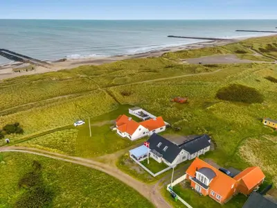 an aerial view of a house and the ocean at Holiday Home Orvo - 150m from the sea by Interhome in Harboør