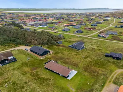 an aerial view of a group of buildings in a field at Holiday Home Elnur - 100m from the sea by Interhome in Harboør