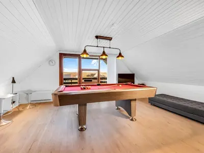 a pool table in the middle of a room at Holiday Home Kristanna - 150m from the sea by Interhome in Harboør