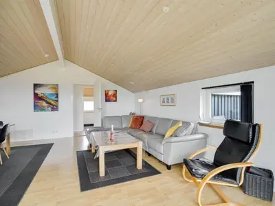 a living room with a couch and a table at Holiday Home Hildegunda - 950m from the sea by Interhome in Harboør
