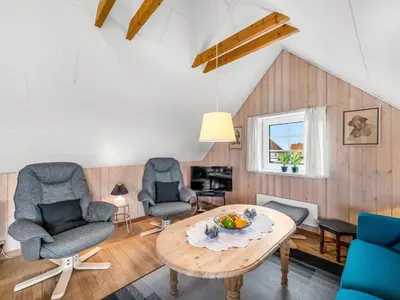 a living room with two chairs and a table at Holiday Home Dietlinde - 100m from the sea by Interhome in Harboør