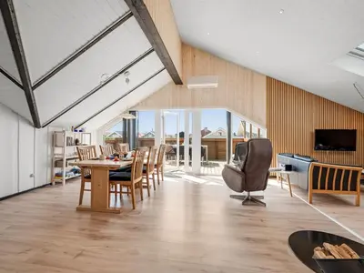 a dining room with a table and chairs at Holiday Home Arla - 200m from the sea by Interhome in Harboør