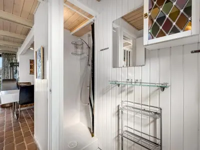 a bathroom with a shower and a glass shelf at Holiday Home Iines - 200m from the sea by Interhome in Harboør