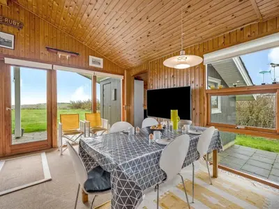 a dining room with a table and chairs at Holiday Home Tanea - 700m to the fjord by Interhome in Lemvig