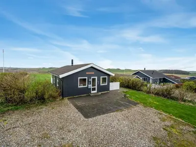 a small house on a gravel driveway at Holiday Home Tanea - 700m to the fjord by Interhome in Lemvig