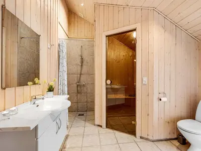 a bathroom with a toilet and a sink and a shower at Holiday Home Elfrun - 250m from the sea by Interhome in Harboør
