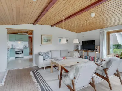 a living room with a couch and a table at Holiday Home Suki - 650m from the sea by Interhome in Torsted
