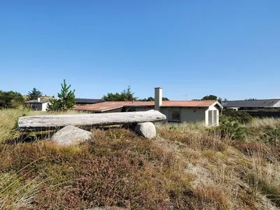 a bench sitting on top of a grassy hill at Holiday Home Suki - 650m from the sea by Interhome in Torsted