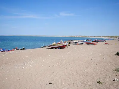 a group of boats sitting on a sandy beach at Holiday Home Suki - 650m from the sea by Interhome in Torsted