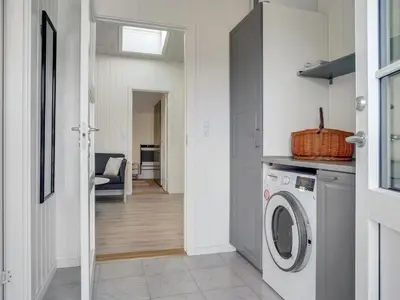 a laundry room with a washer and dryer at Holiday Home Ibo - 900m from the sea by Interhome in Torsted