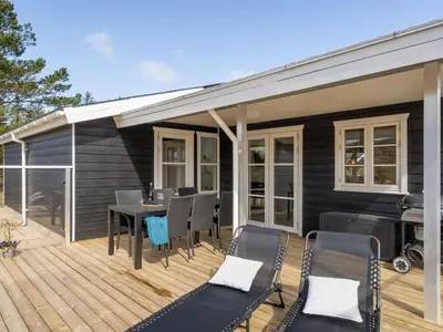 a patio with a table and chairs on a deck at Holiday Home Ibo - 900m from the sea by Interhome in Torsted