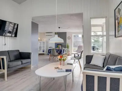 a living room with a couch and a table at Holiday Home Ibo - 900m from the sea by Interhome in Torsted