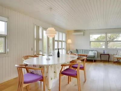 a dining room with a table and chairs at Holiday Home Vilja - 150m from the sea by Interhome in Torsted