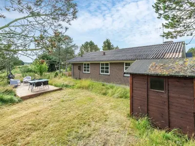 a backyard with a house and a patio at Holiday Home Aurelie - 800m from the sea by Interhome in Torsted
