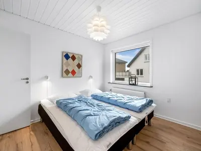 a bedroom with a bed and a window at Holiday Home Eluisa - 300m from the sea by Interhome in Thyborøn