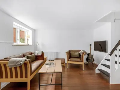 a living room with a couch and a table at Holiday Home Eluisa - 300m from the sea by Interhome in Thyborøn