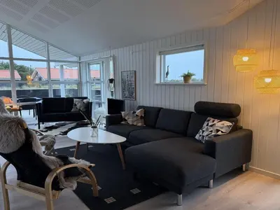 a living room with a couch and a table at Holiday Home Mauri - 350m from the sea by Interhome in Torsted