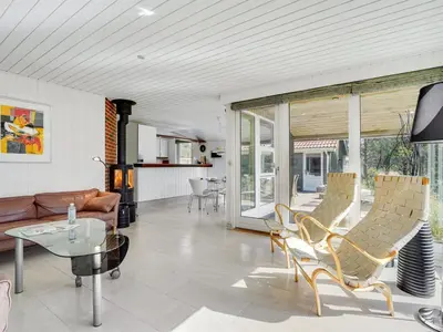 a living room with a couch and a table at Holiday Home Henkil - 700m from the sea by Interhome in Torsted