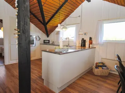 a kitchen with a white island in a room at Holiday Home Sakulf - 600m from the sea by Interhome in Torsted
