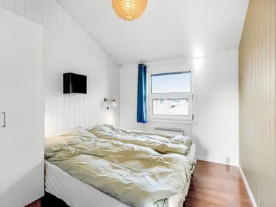 a bedroom with a bed in a room with a window at Holiday Home Antto - 900m from the sea by Interhome in Torsted