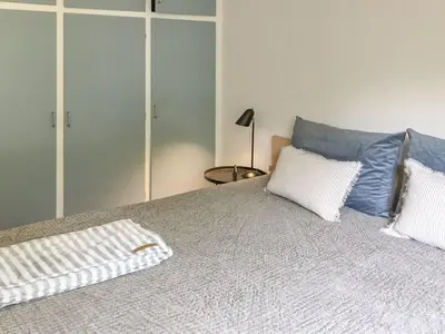 a bedroom with a bed with two pillows on it at Holiday Home Flor - 900m from the sea by Interhome in Torsted
