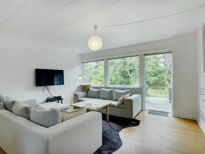 a living room with a couch and a table at Holiday Home Flor - 900m from the sea by Interhome in Torsted