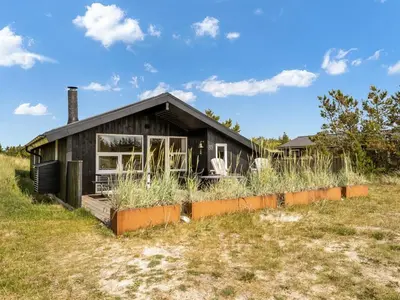 a small house on top of a grass field at Holiday Home Suleika - 900m from the sea by Interhome in Torsted