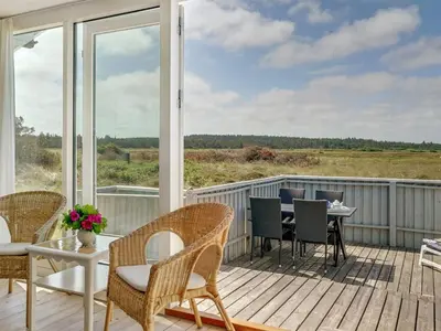 a porch with chairs and a table on a deck at Holiday Home Tayanita - 750m from the sea by Interhome in Torsted