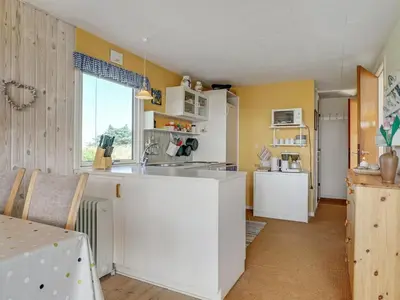 a kitchen with a white island in a room at Holiday Home Tayanita - 750m from the sea by Interhome in Torsted