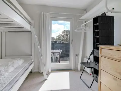 a bedroom with a bunk bed and a window at Holiday Home Tayanita - 750m from the sea by Interhome in Torsted